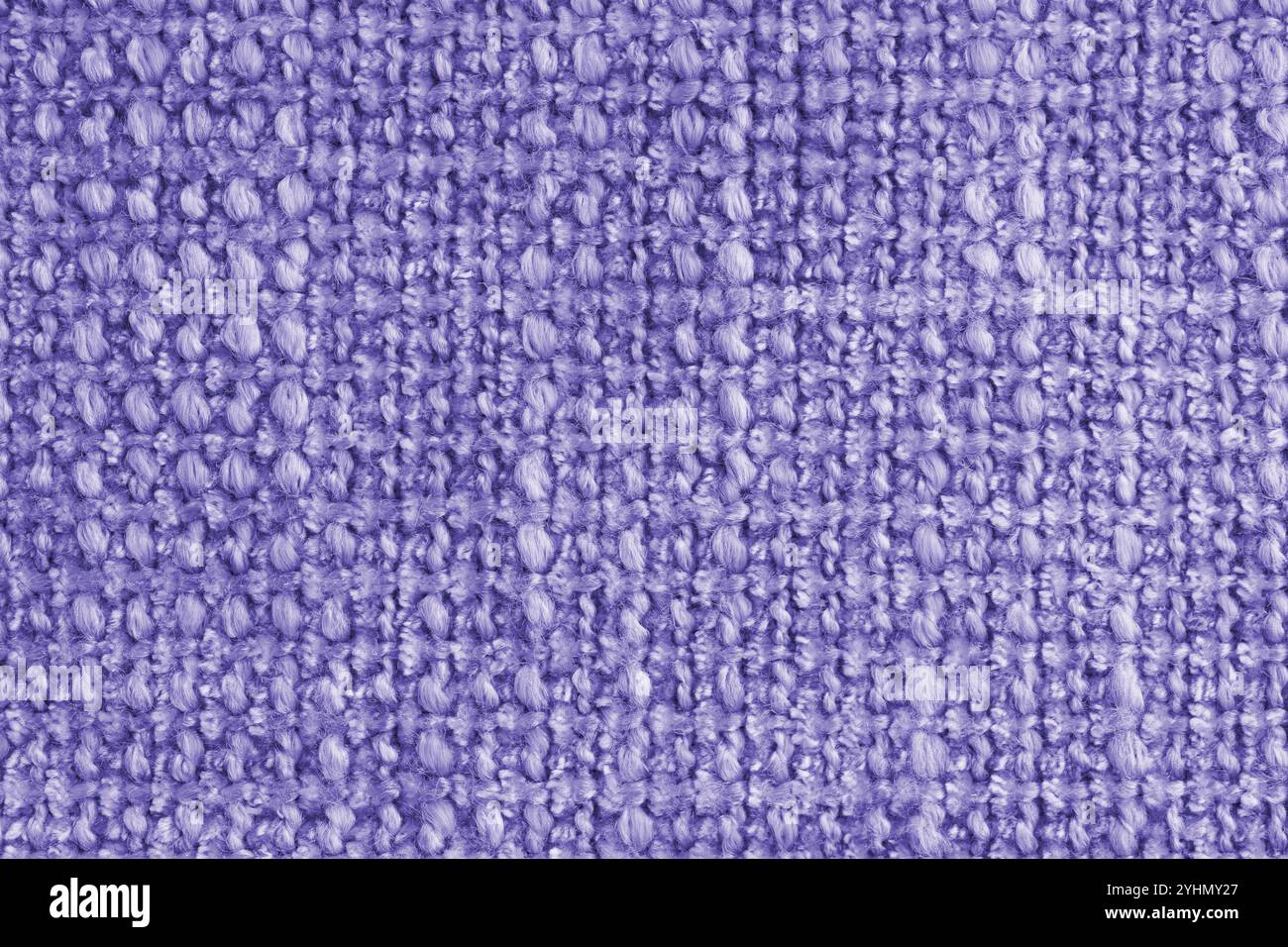 Texture of purple jacquard fabric of rough weave, cloth structure background, close up, macro. Material for home textile, upholstery and curtain decor Stock Photo