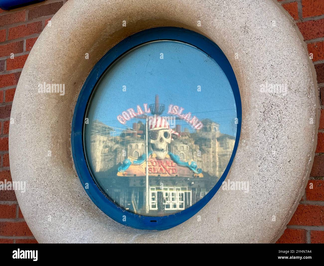 Coral Island amusement arcade reflected in circular window of Blackpool lifeboat station the promenade - Smartphone Captured Stock Image