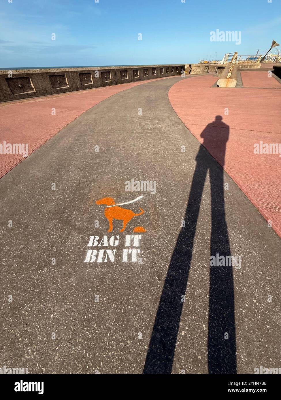 bag it bin it sign on Blackpool South promenade with shadow of figure - Smartphone Captured Stock Image
