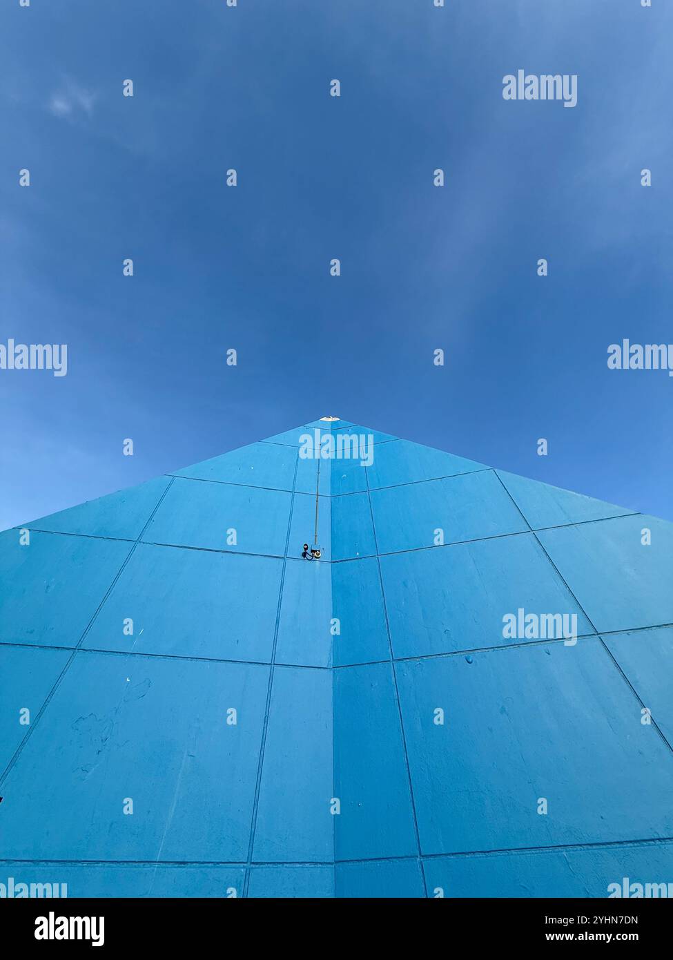 Wall of Sandcastle swimming pool complex forming arrow pointing upwards to a vivid blue sky, Blackpool UK - Smartphone Captured Stock Image