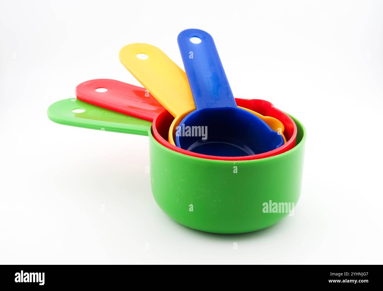 Colourful plastic kitchen measures on white background Stock Photo