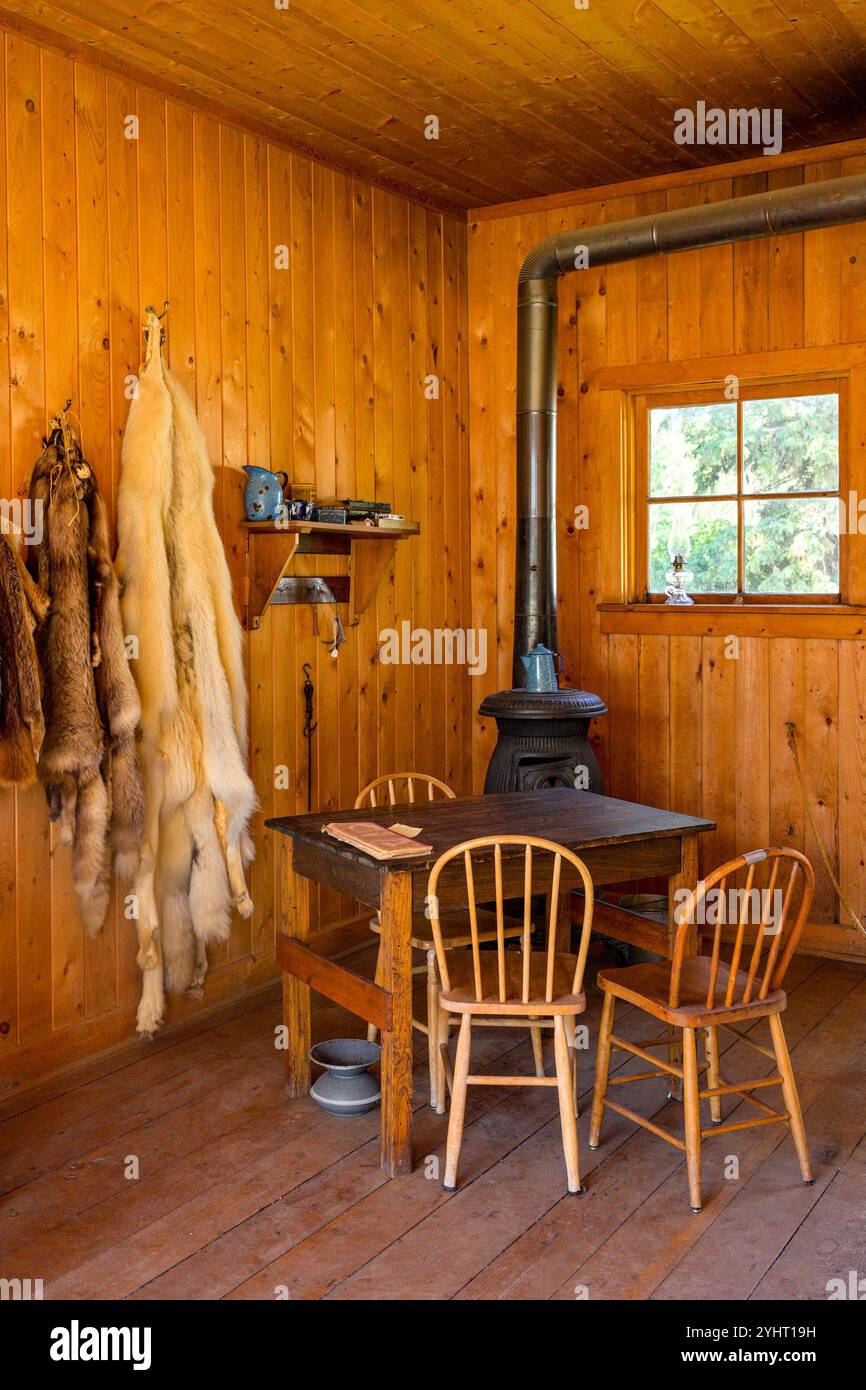 Fur pelts and wood stove, cabin,  Fort Edmonton Park, Edmonton, Alberta, Canada Stock Photo