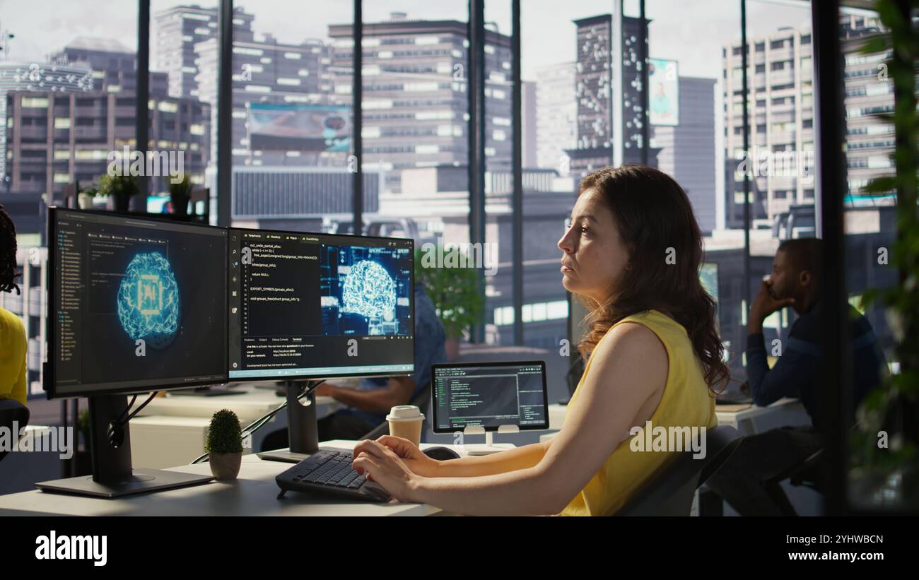 Admin developing artificial intelligence machine learning APIs solving complex problems. Woman training AI predictive models capable of handling resource intensive tasks, camera B Stock Photo