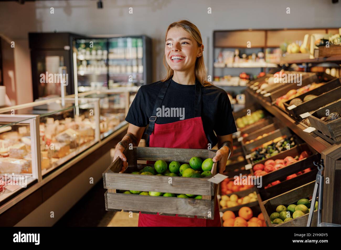 Fresh Produce Display in Grocery Store Featuring a Smiling Employee ...