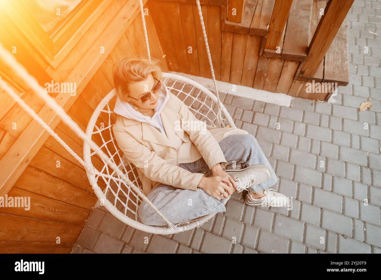 Garden hanging chair woman hi-res stock photography and images - Alamy