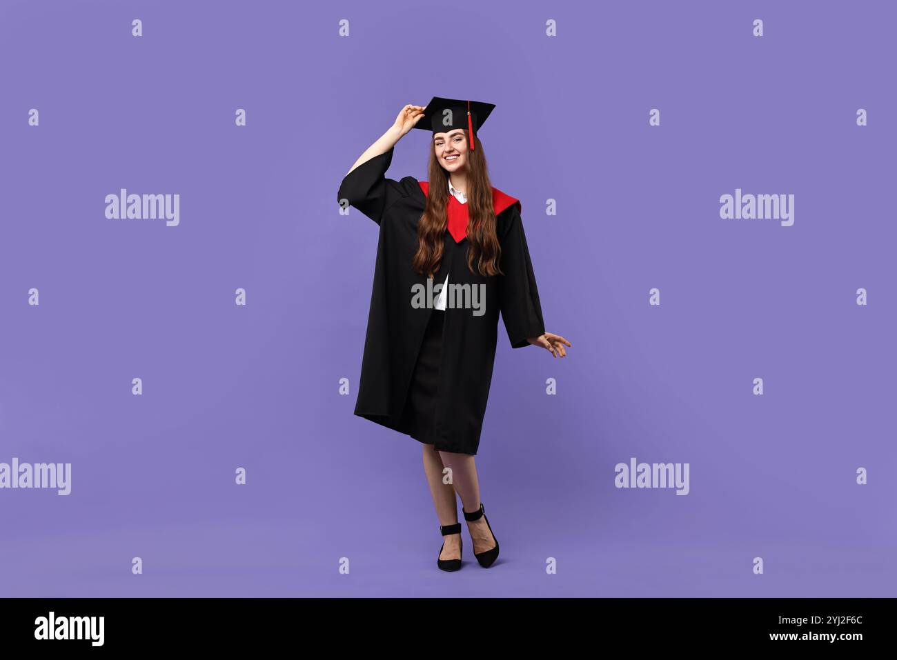 Happy student after graduation on violet background Stock Photo - Alamy