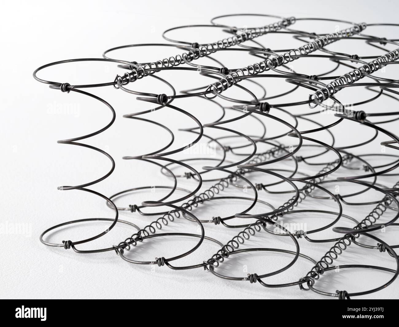 Still life of an iron spring, component of a net inside a bed mattress ...