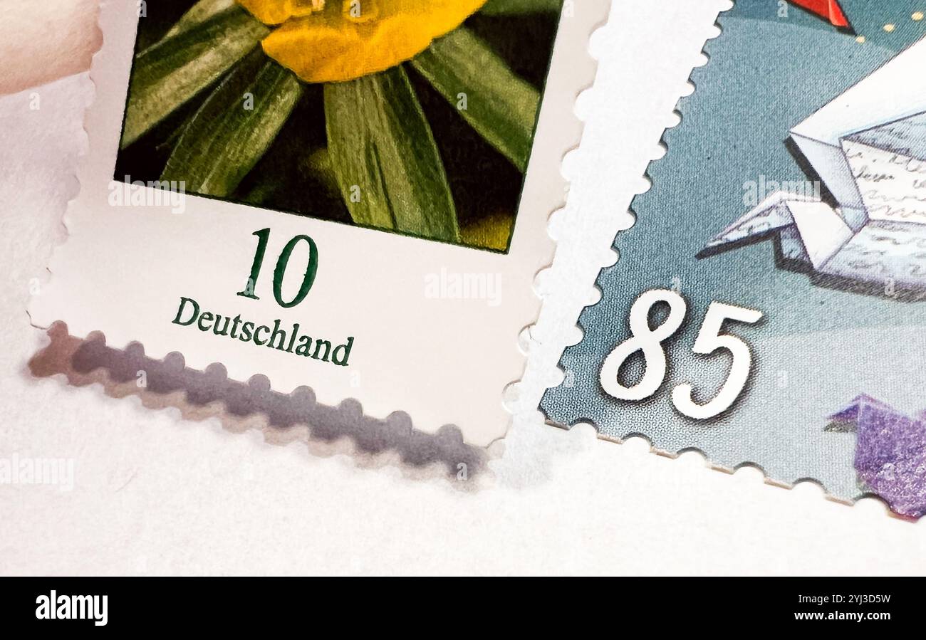 ILLUSTRATION - 13 November 2024, Lower Saxony, Hanover: A 10-cent stamp is stuck next to an 85-cent stamp (posed scene). From January, sending a standard letter within Germany will cost 95 cents, 10 cents more than before. This was proposed by Deutsche Post on 13.11.2024. Photo: Julian Stratenschulte/dpa Stock Photo