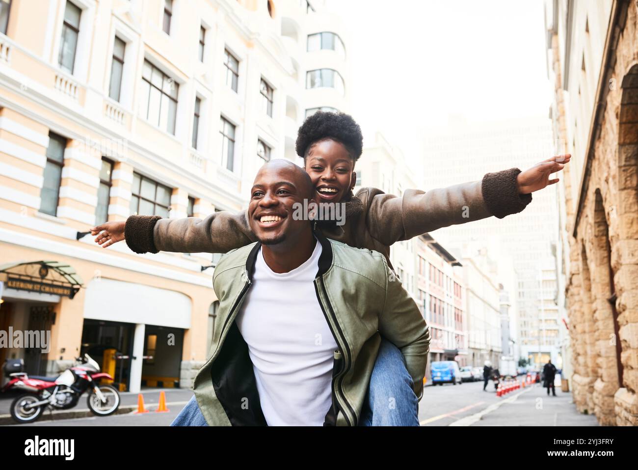 Joyful Couple Enjoying a Playful Piggyback Ride Through the City ...