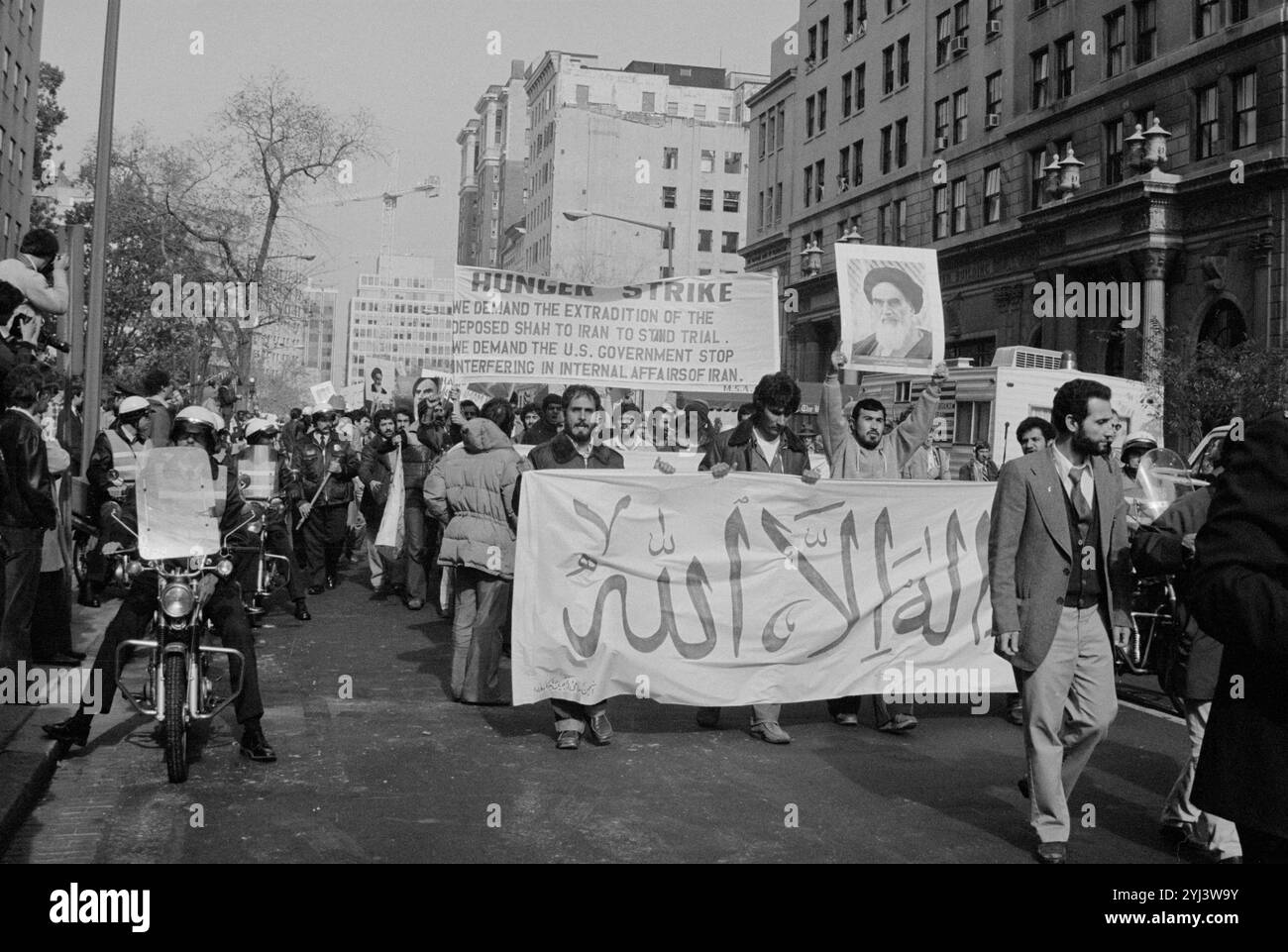 Iranian students with signs and banners marching in the street during a