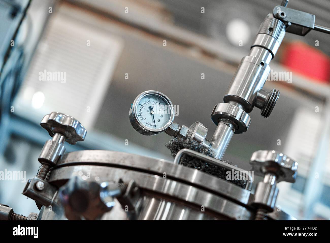 A close-up of a pressure gauge attached to a metal tank in a ...