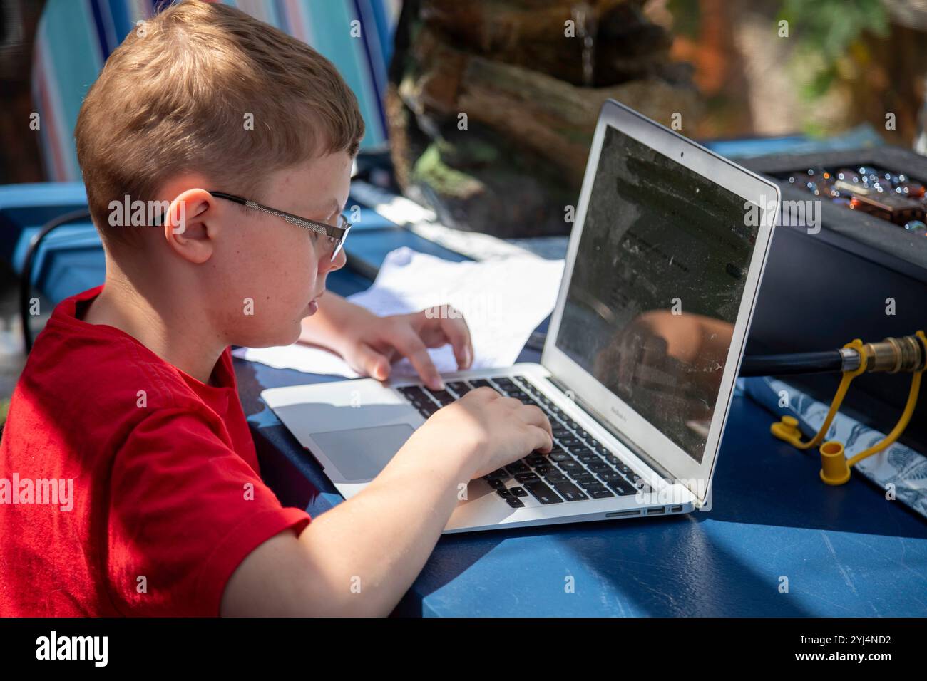 Denver, Colorado - Ten-year-old Adam Hjermstad Jr. works on a laptop computer. Stock Photo