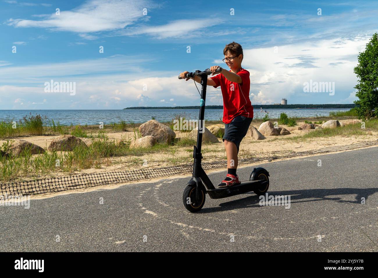 Boy riding electric scooter hi-res stock photography and images - Alamy