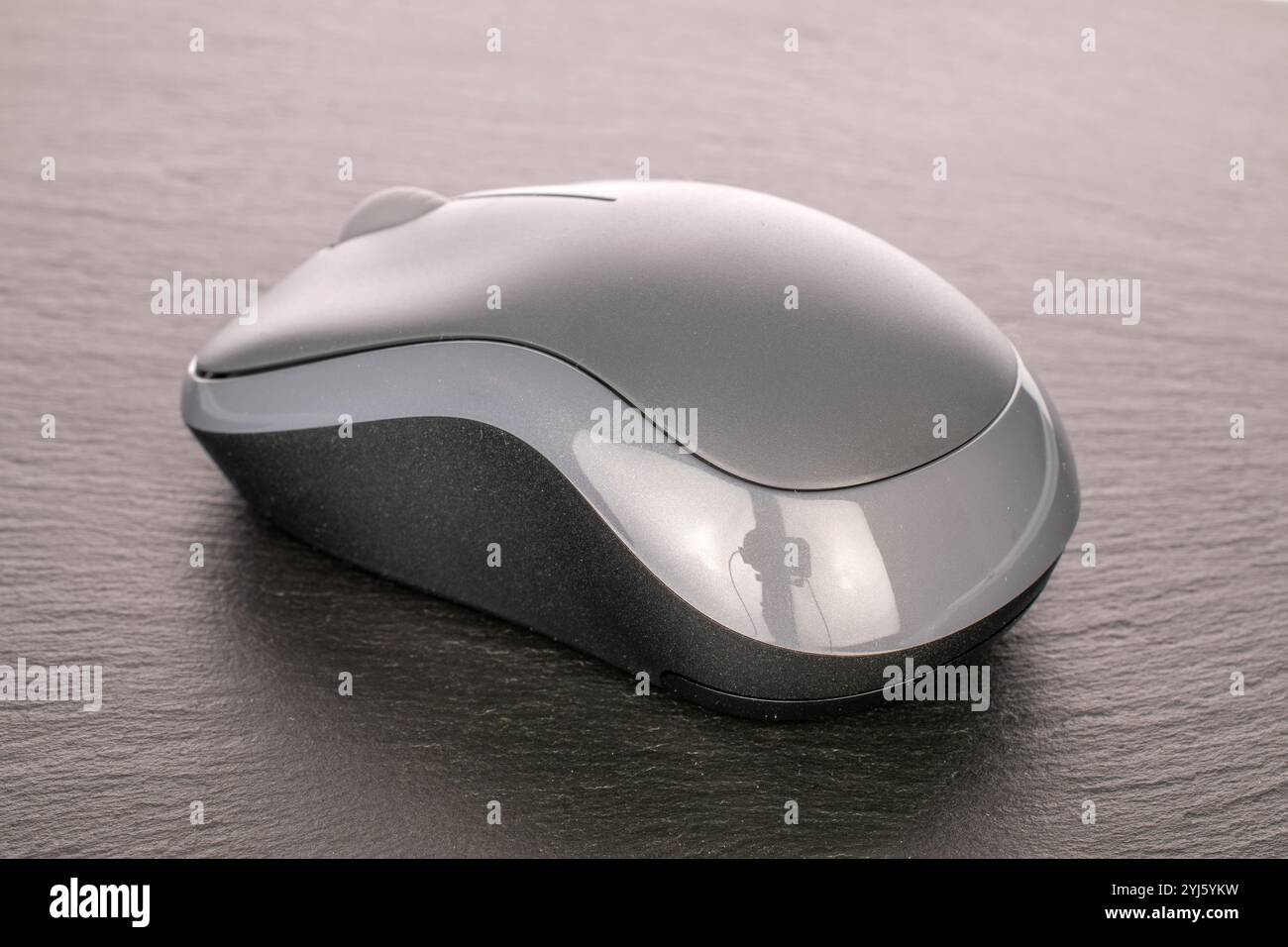 One wireless computer mouse on slate stone, macro. Stock Photo