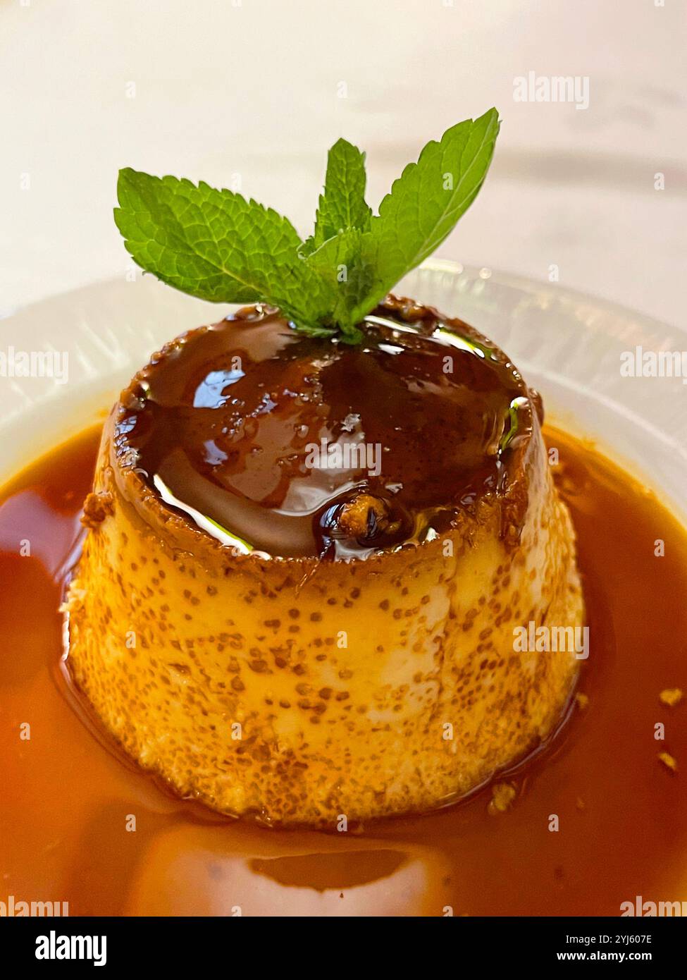 Creme caramel witn mint leaves. - Smartphone Captured Stock Image