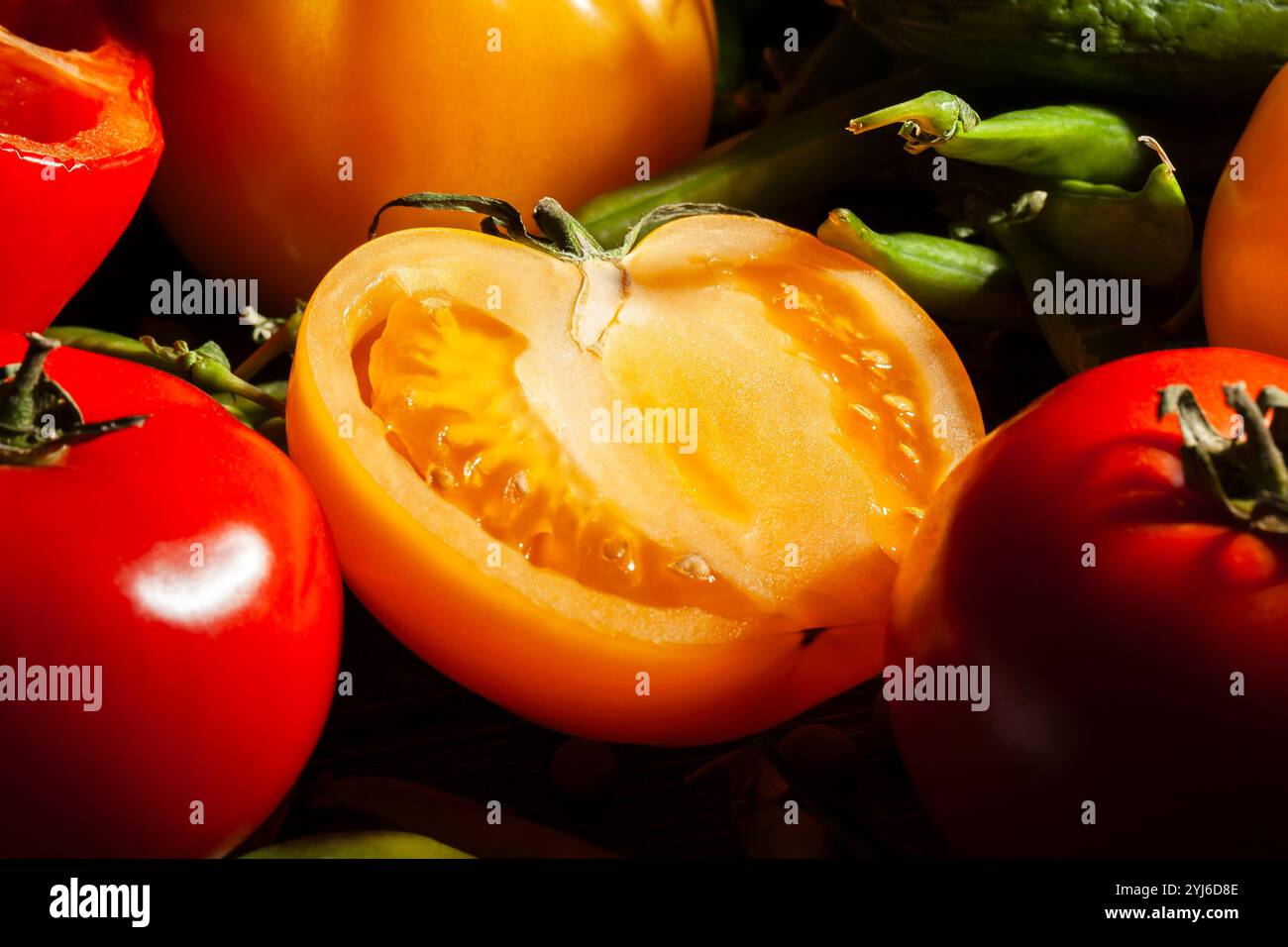 sliced yellow tomato on black background Stock Photo