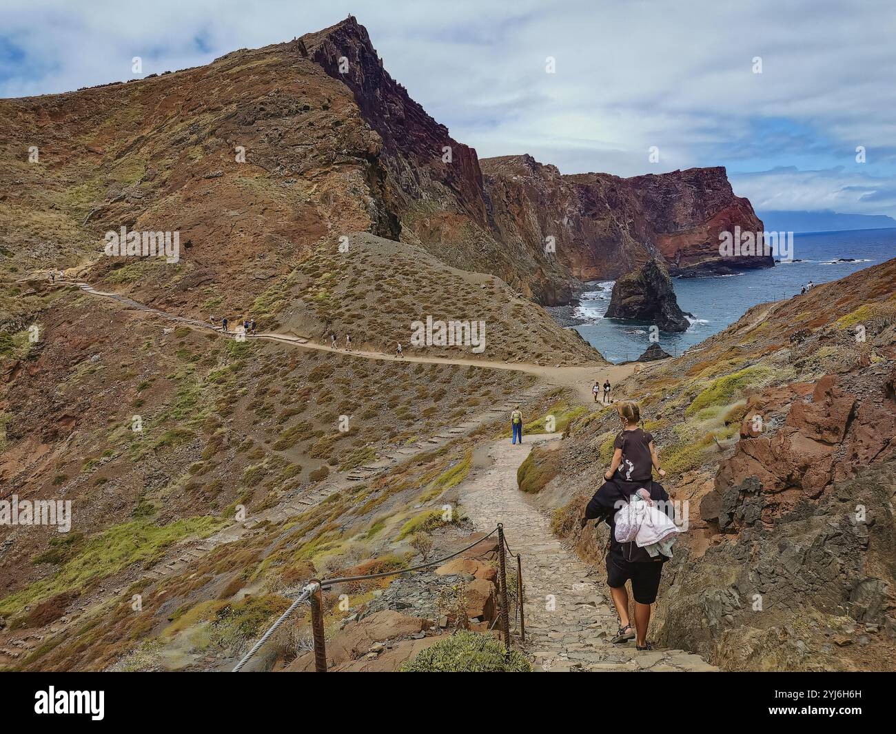 Hikers on a rugged trail along the dramatic cliffs of Ponta de São Lourenço, Madeira, with coastal views. Stock Photo