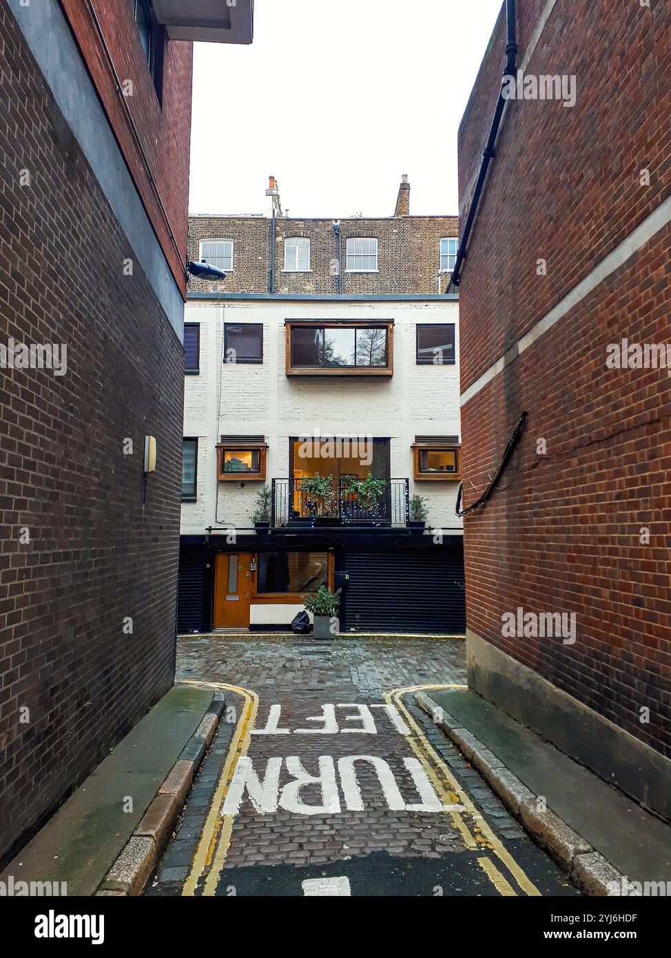 Narrow alley with cobblestone pavement and a
