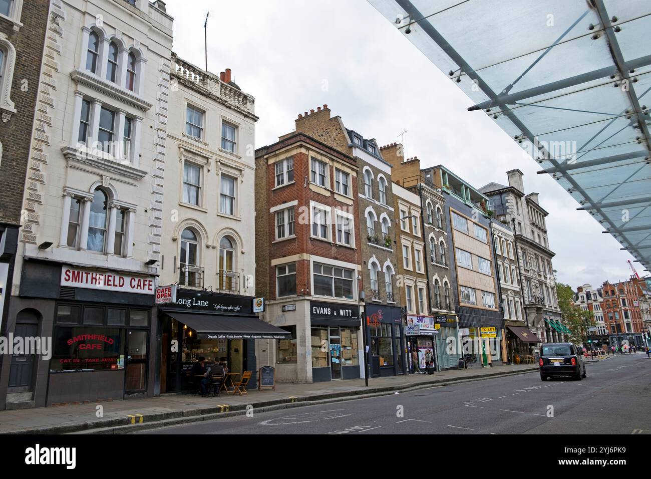 View of buildings, small shop, cafes on Long Lane empty street opposite Smithfield Market in the City of London England UK Britain 2024 KATHY DEWITT Stock Photo