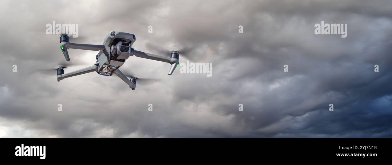 Unmanned Aircraft System (UAV) Quadcopter Drone In The Air On A Cloudy ...