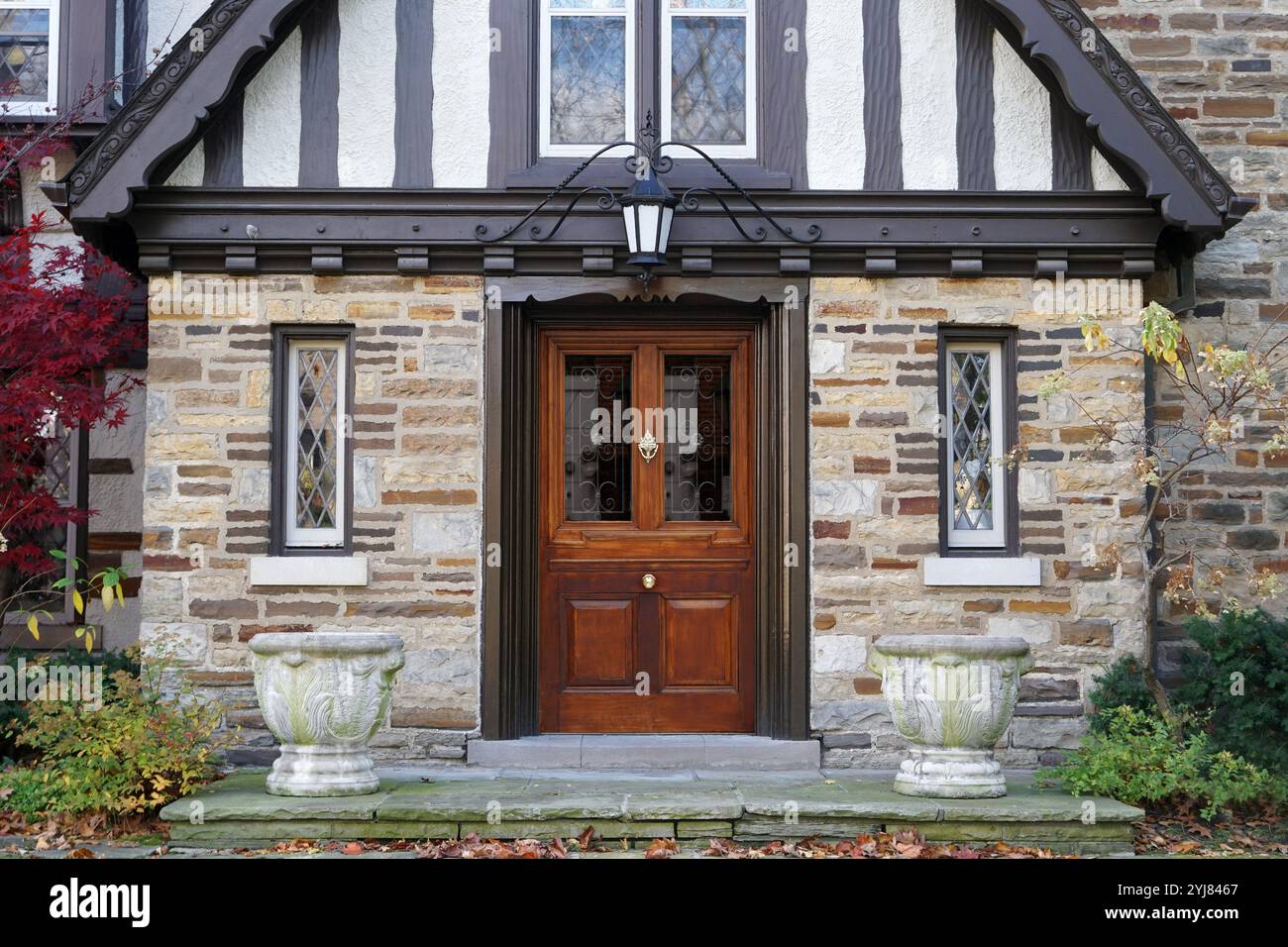 Elegant wood grain front door of Tudor style house Stock Photo