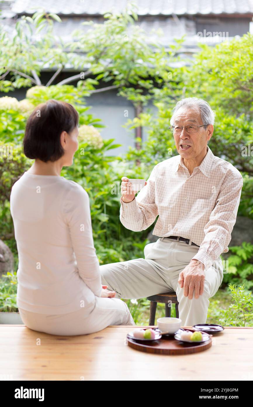 Senior woman sitting on veranda hi-res stock photography and images - Alamy