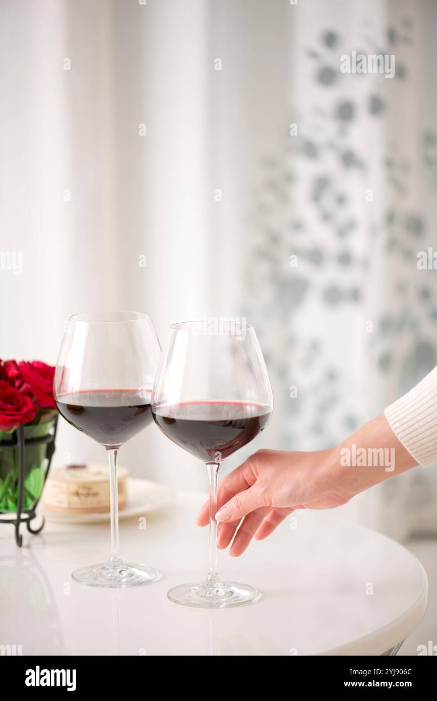 Woman's hand holding a glass of red wine Stock Photo