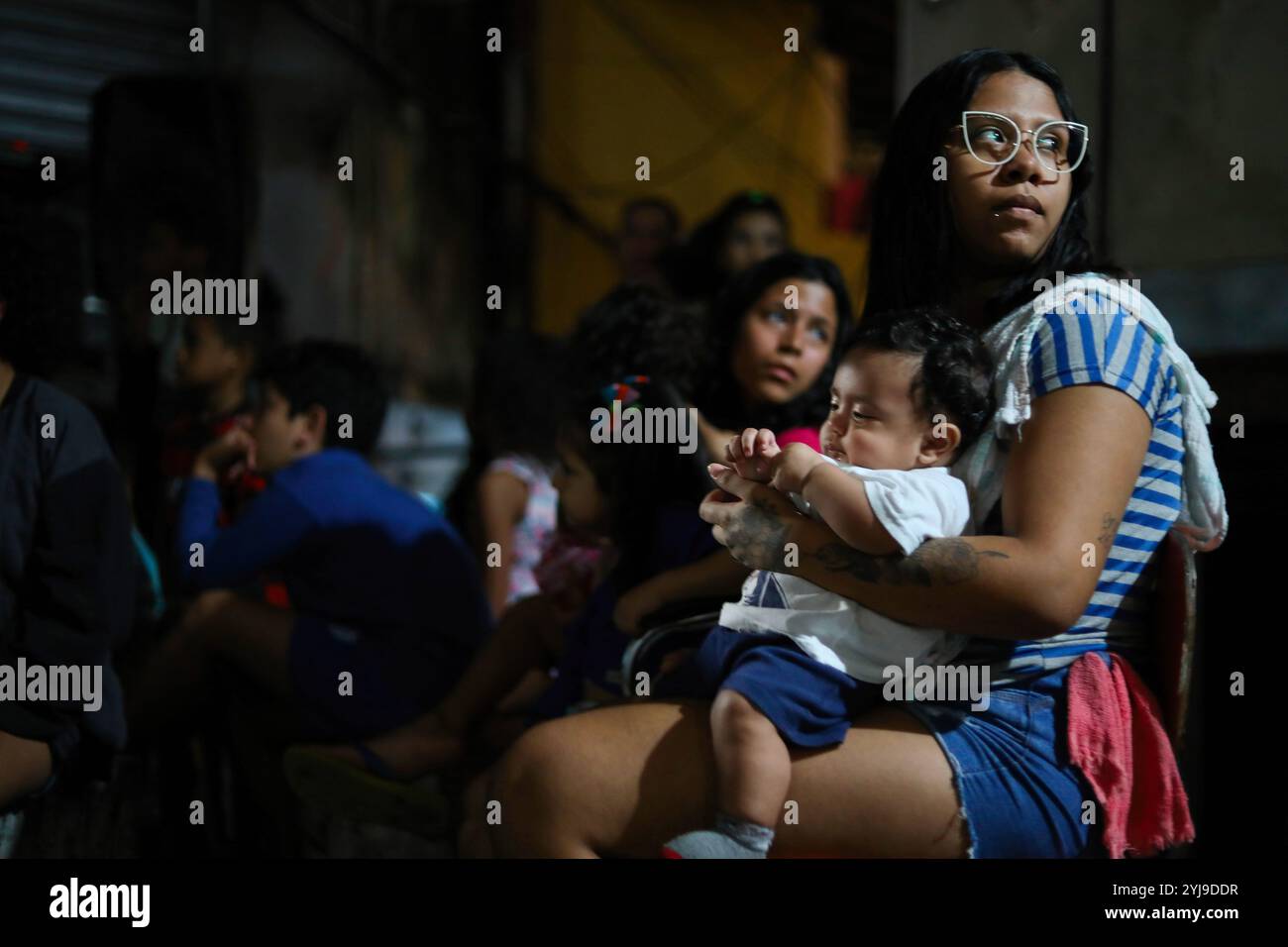 Rio De Janeiro, Brazil. 16th Oct, 2022. Residents of Vidigal's favela in Rio de Janeiro watch a film projected on an alley wall. For people living in the favelas of Rio de Janeiro, Brazil, going to the movies is an expensive and remote pastime. So every week, an associative film club offers an open-air screening in the Vidigal favela. (Photo by Apolline Guillerot-Malick/SOPA Images/Sipa USA) Credit: Sipa USA/Alamy Live News Stock Photo