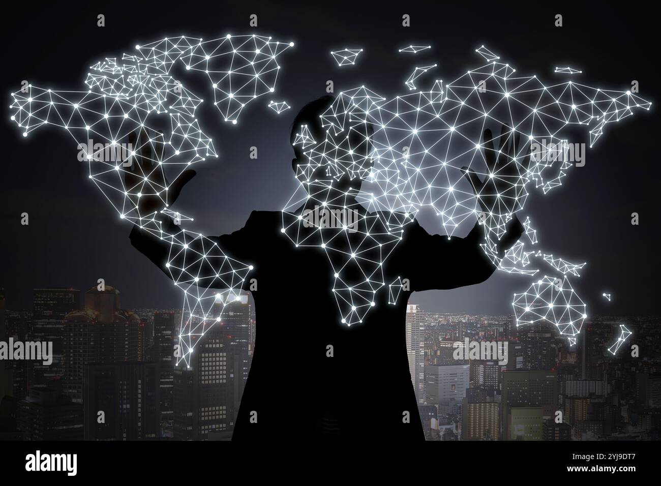 Shadow of a person producing a hologram of a world map with both hands ...