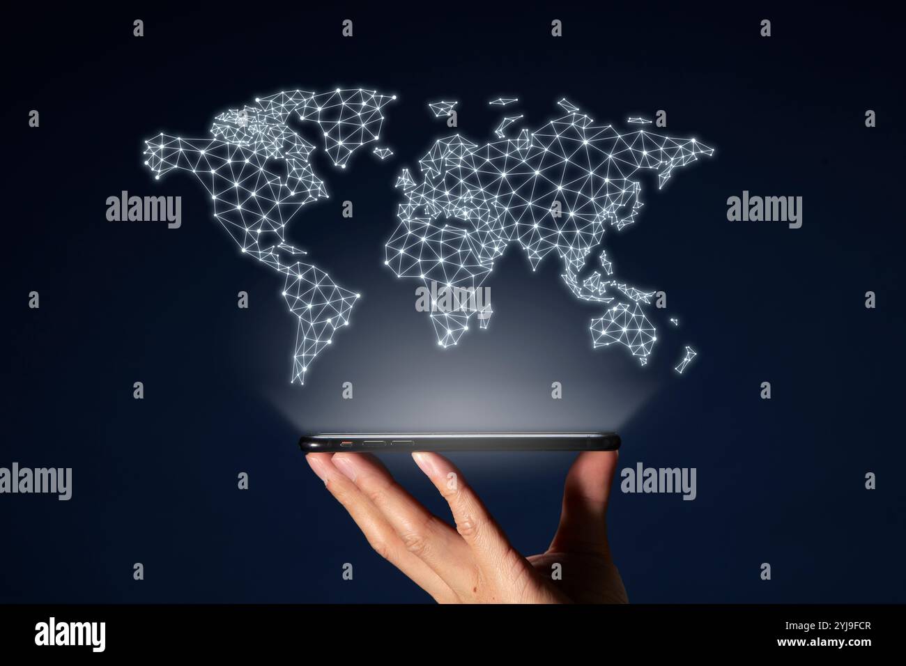 Hand holding a smartphone and a world map with floating dots and lines ...