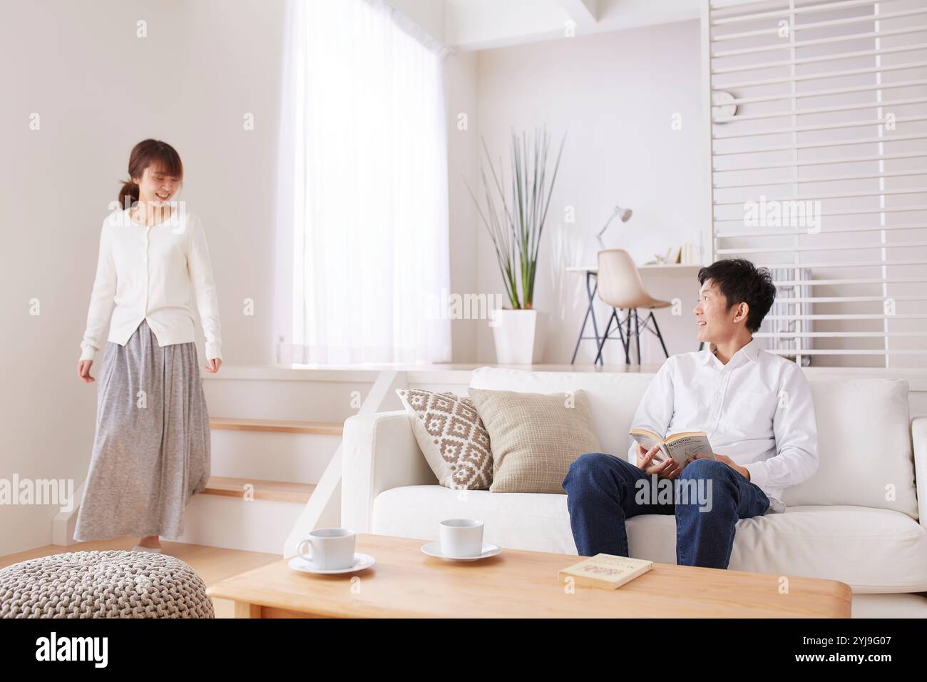Man sitting woman walking table hi-res stock photography and images - Alamy