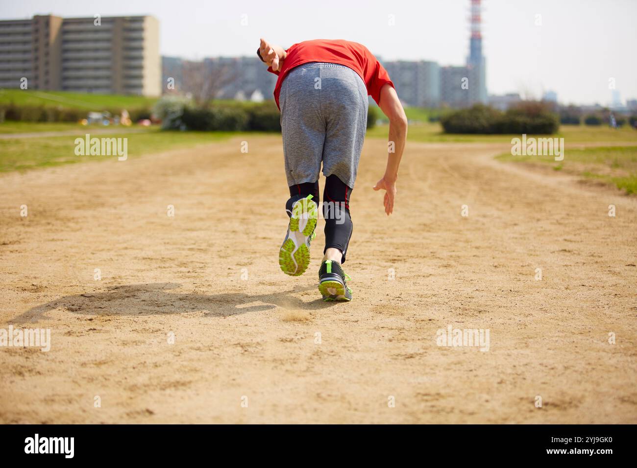 Back view of sportsman running on the ground Stock Photo - Alamy