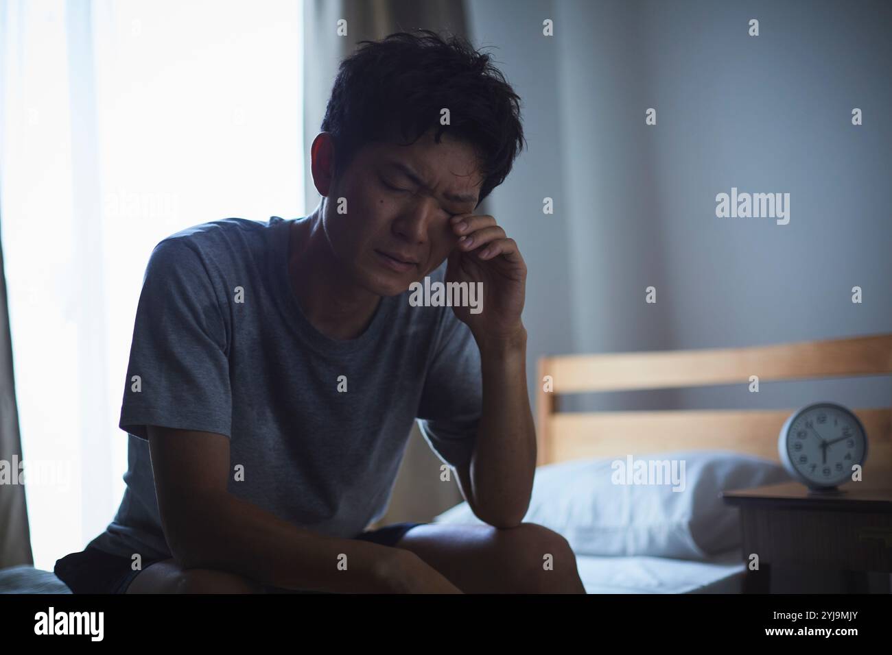 Man unable to sleep due to tropical night Stock Photo - Alamy