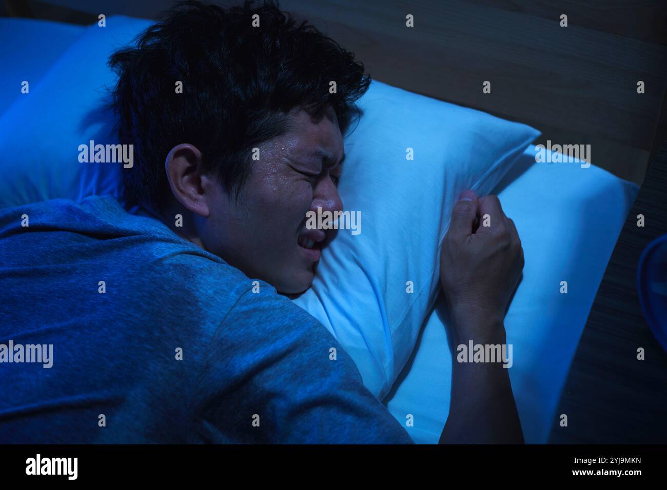 Man unable to sleep due to tropical night Stock Photo - Alamy