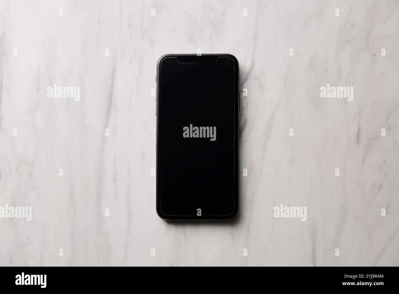 Smartphone placed on marble baking sheet Stock Photo