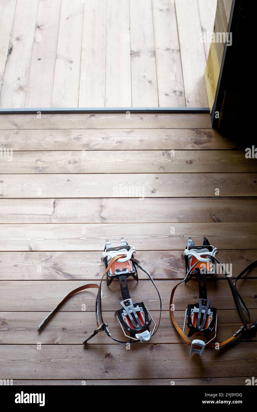 Crampons on the floor near the hut entrance Stock Photo