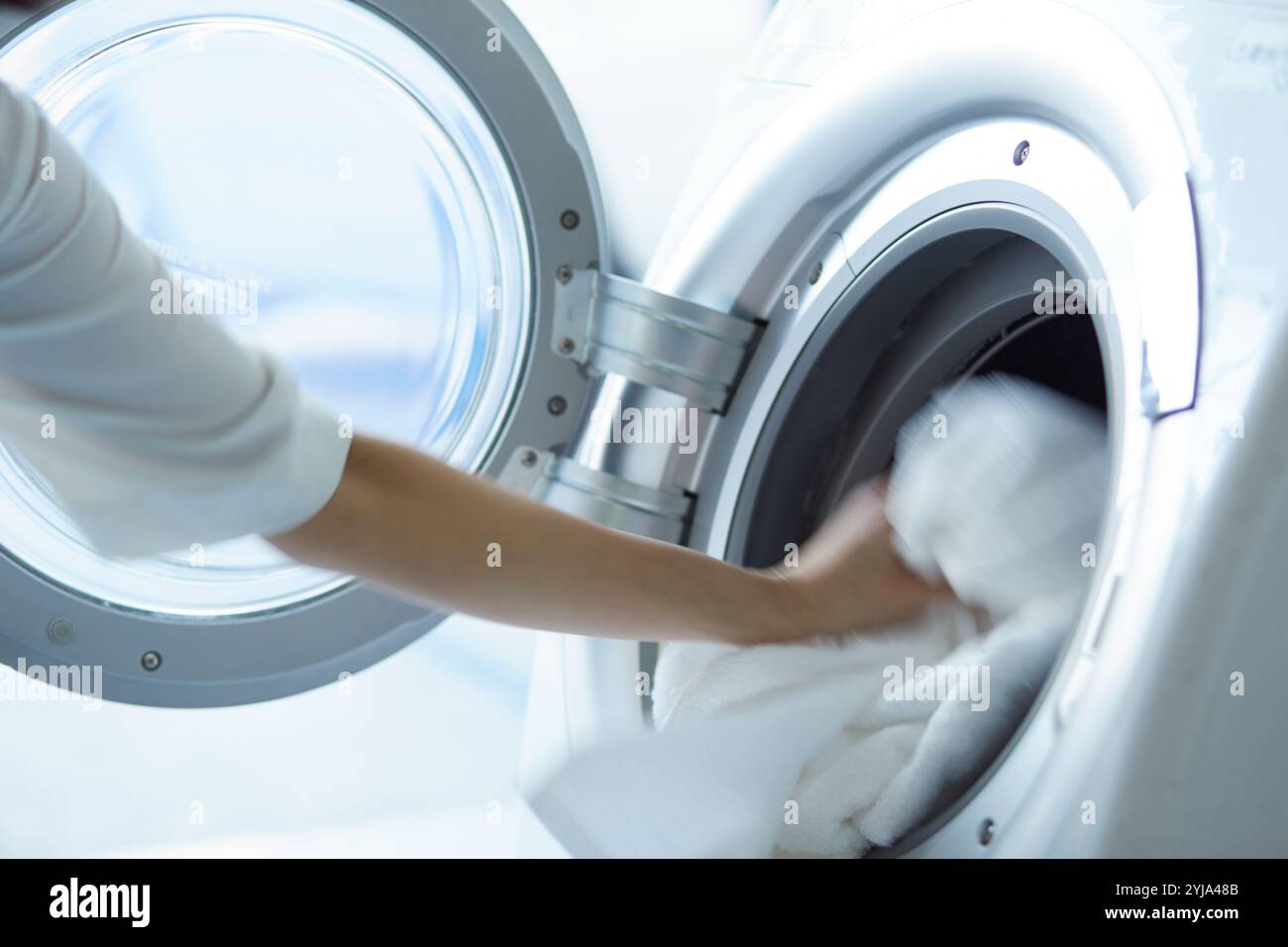 Person loading washing machine hi-res stock photography and images - Alamy