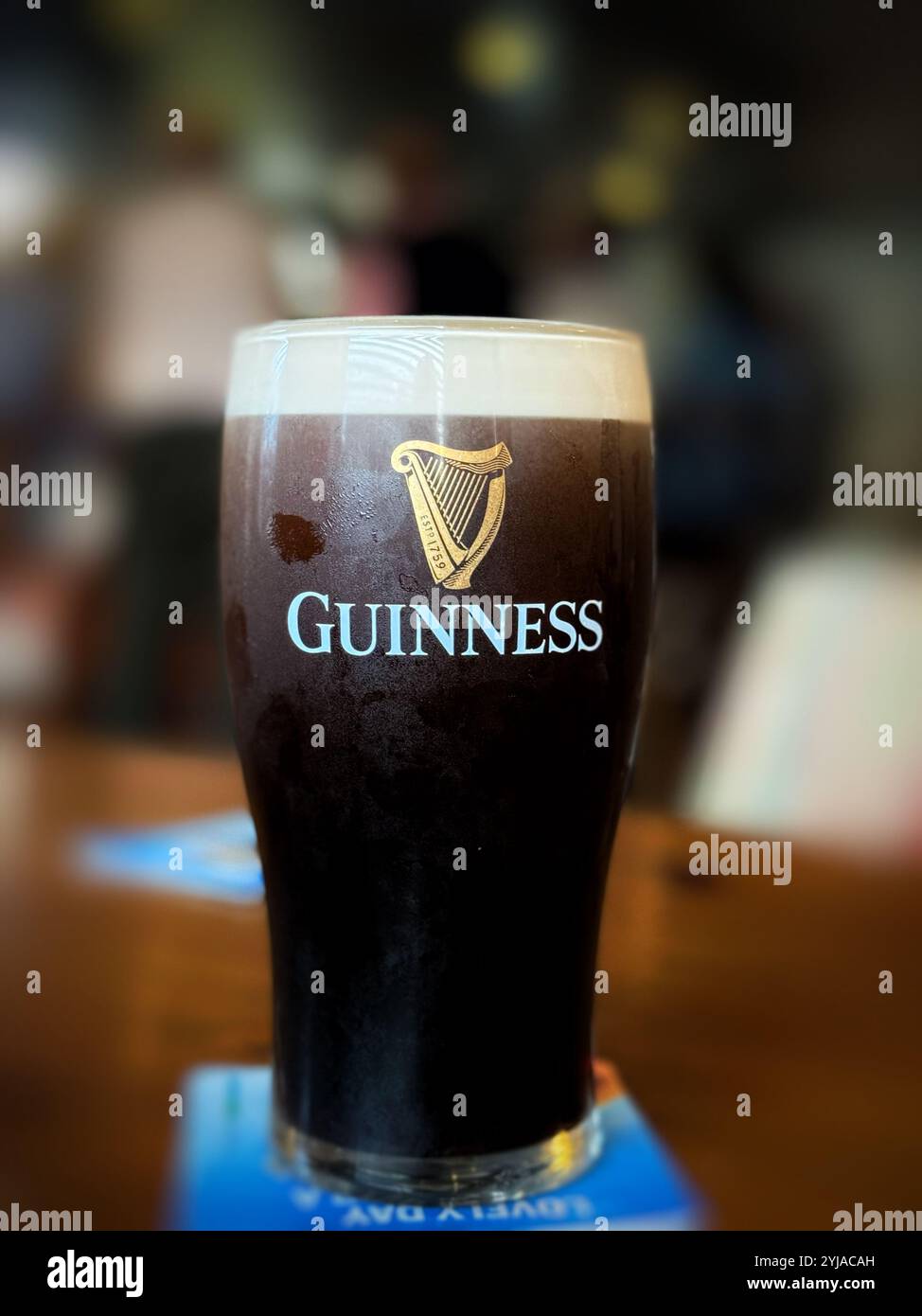 A cold pint of Guinness in an Irish pub (Tig Rosie - Sigerson's Bar), Ballinskelligs bay. - Smartphone Captured Stock Image