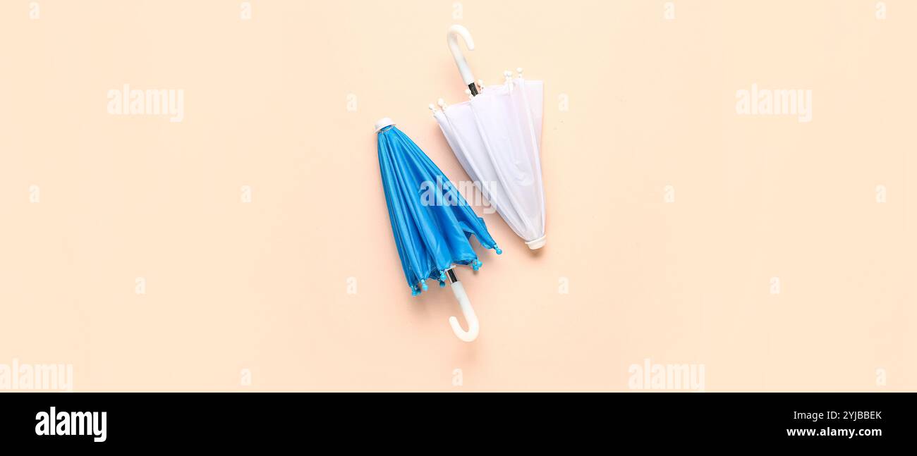 Different umbrellas on beige background, top view Stock Photo