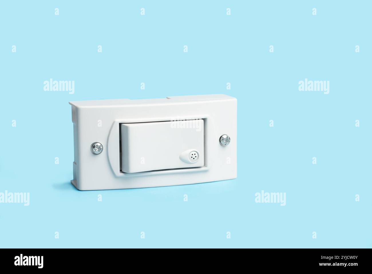 Light switch on a light blue background with copy space Stock Photo