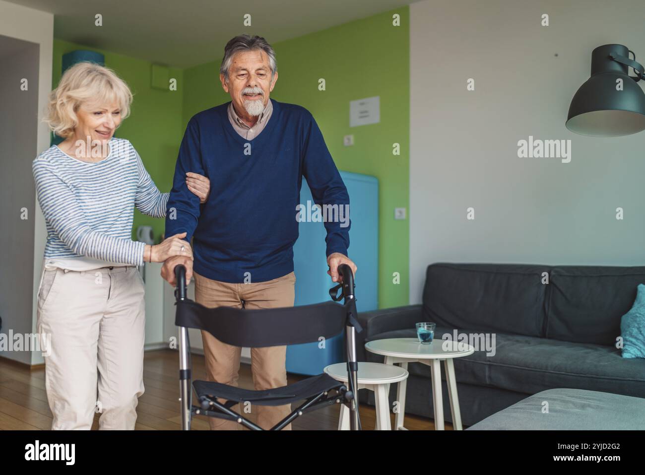 Senior woman helping man walk hi-res stock photography and images - Alamy