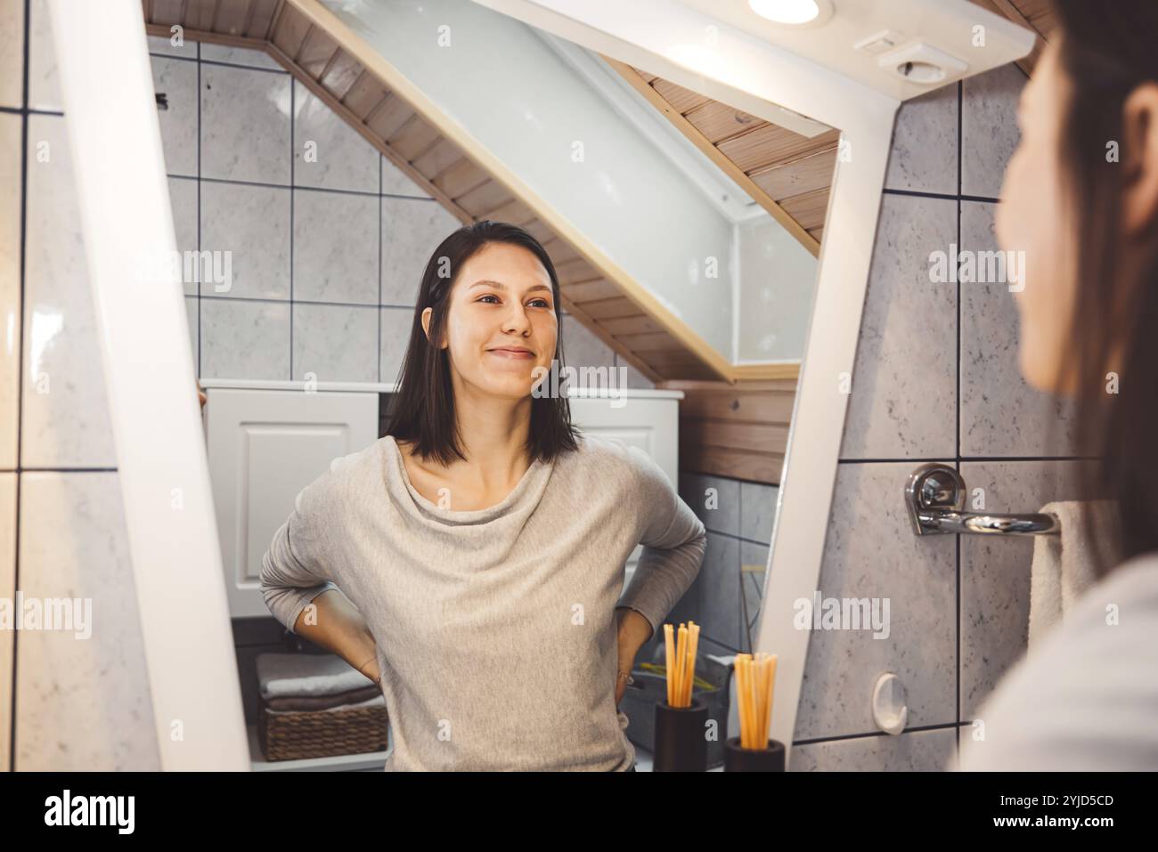 Beautiful young woman cleaning her face, removing make up with a cotton pad and micellar water. Skin care and beauty. Young beautiful woman cleaning h Stock Photo