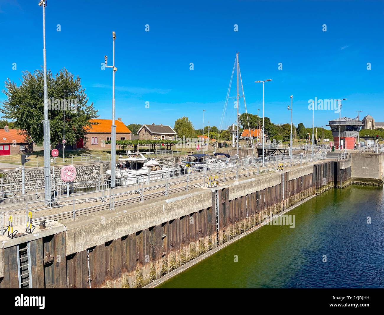 Veere, Zeeland, The Netherlands - 10 August 2022: Boats and yachts in the canal lock in the town of Veere. - Smartphone Captured Stock Image