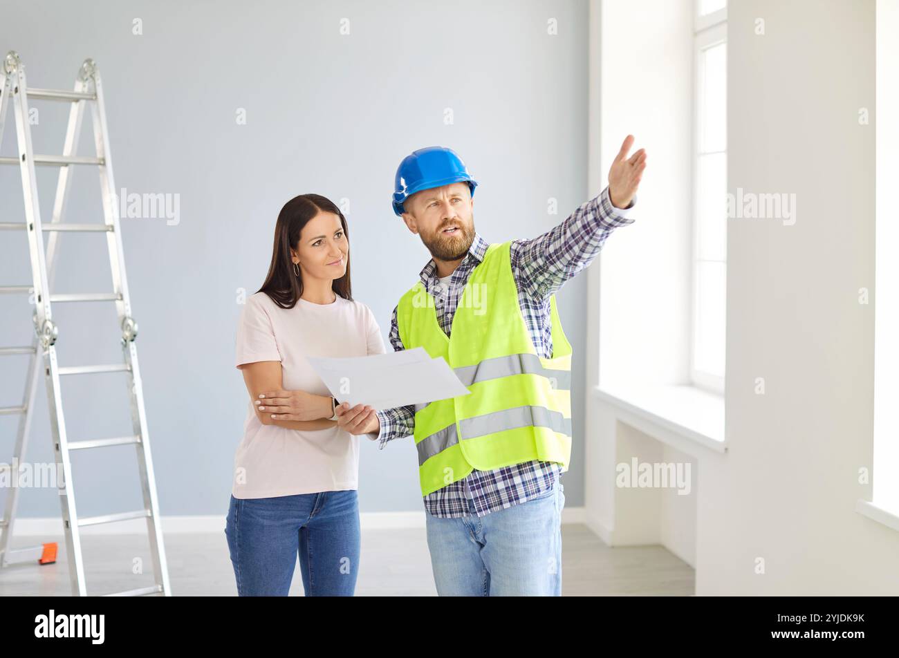 Skilled professional repairman explaining, architect construction worker with talking to client  Stock Photo