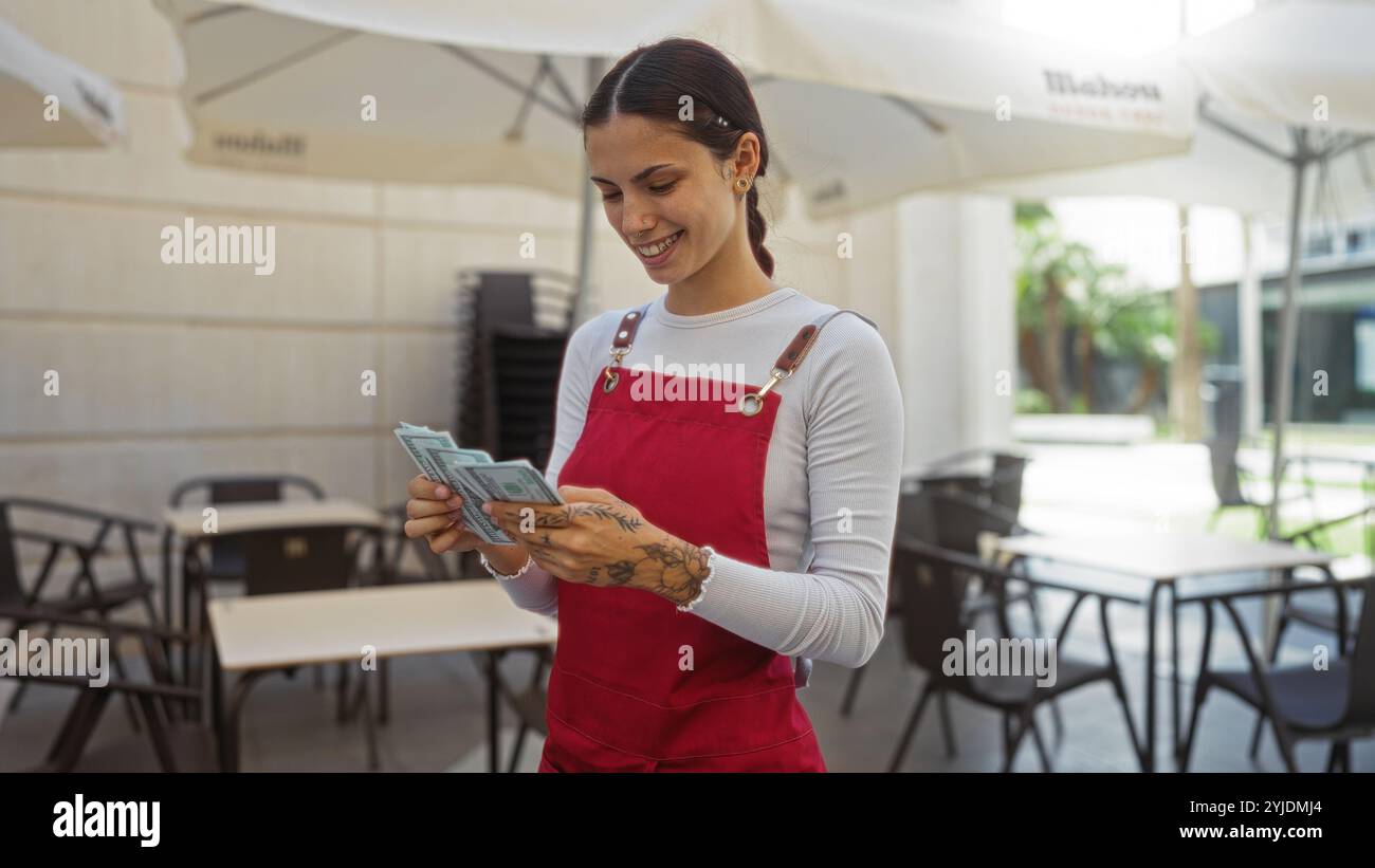 Smiling latina woman wearing apron hi-res stock photography and images ...