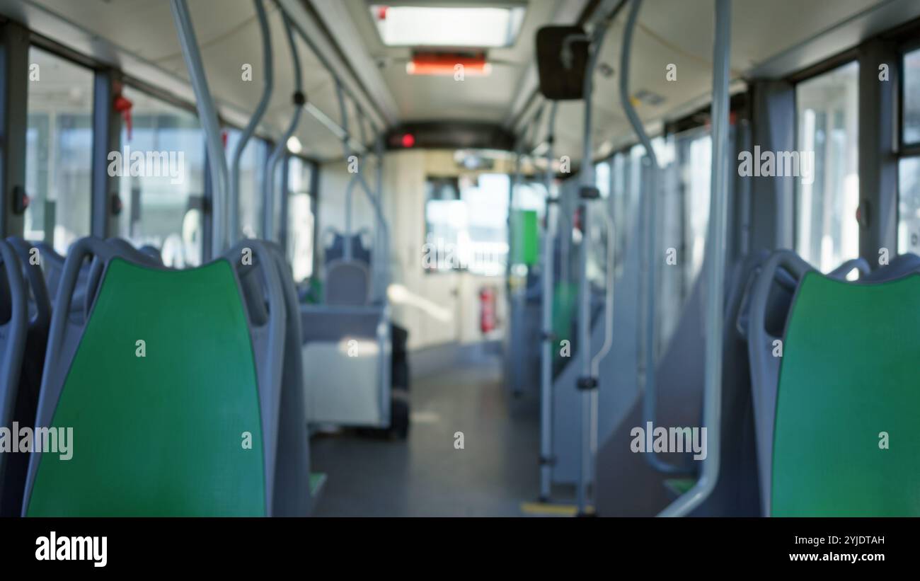 Empty bus interior with green seats and blurred background, showcasing ...
