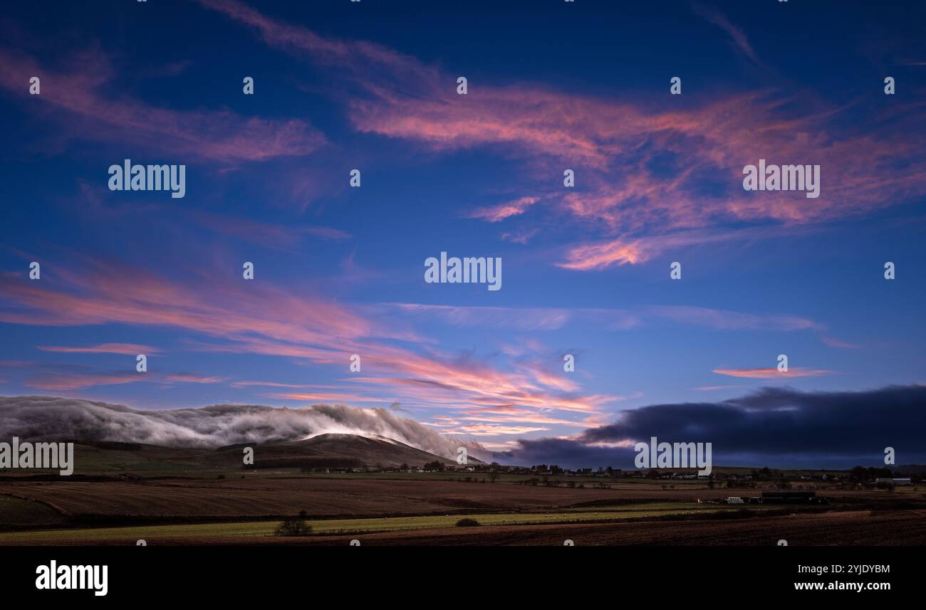 Wispy clouds at sunset over Tinto Hill in South Lanarkshire, Scotland Stock Photo