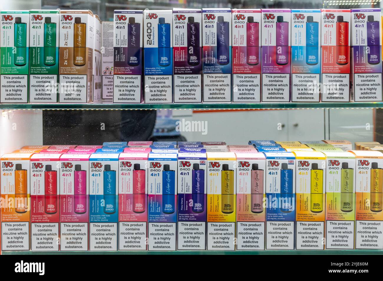 Display of colourful vapes in a shop window with a variety of fruit flavours, England, UK. Concept: youth vaping, attractive products for children Stock Photo