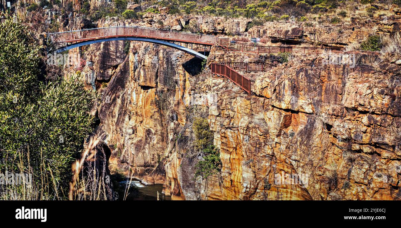 View of A breathtaking bridge spans across a deep, rocky canyon, showcasing ...