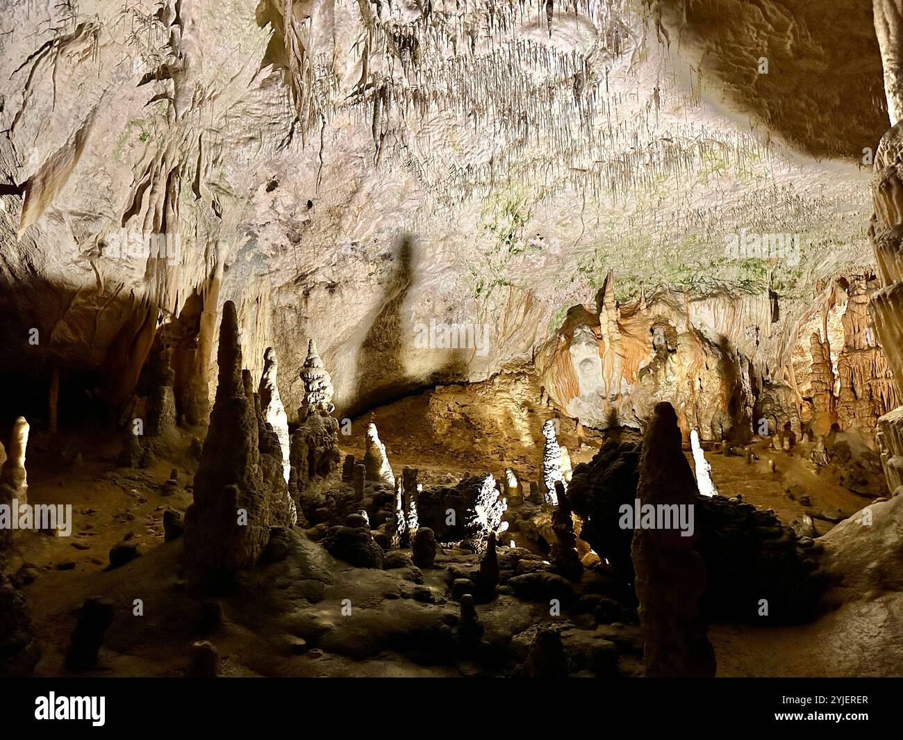 A photography captures a close-up of vibrant stalactites within a secluded cave. - Smartphone Captured Stock Image